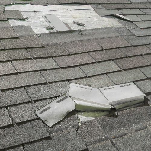 a row of asphalt shingles hanging off roof